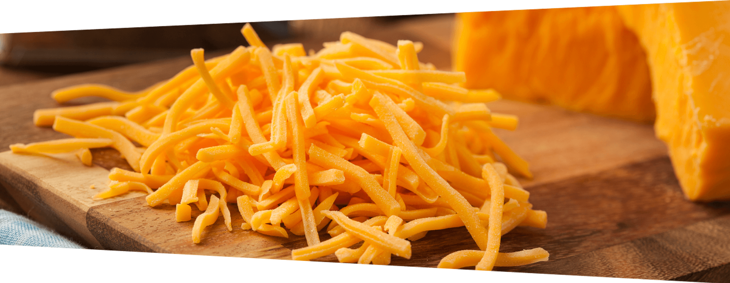 Image Of Grate Cheddar Cheese On A Cutting Board - Great Cheese (2516x978), Png Download